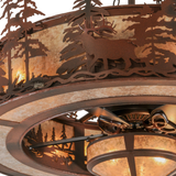 Closeup lit detail highlighting elk figure and rustic bronze finish.