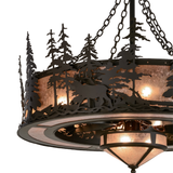 Closeup angle lit view showing elk silhouette and tree cutouts.