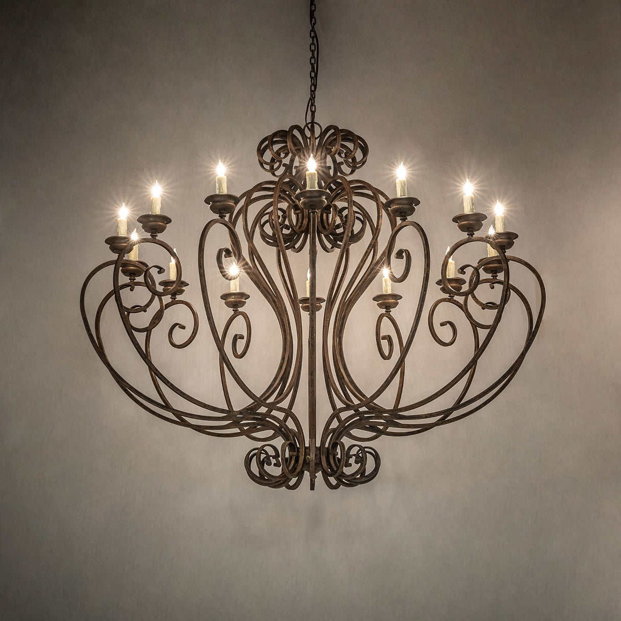 Fernando 14 light chandelier glowing in antiquity finish with scrollwork design.
