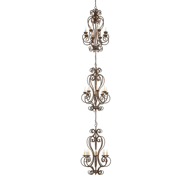 Lit view of three-tier chandelier with scrollwork design and faux candlelights.
