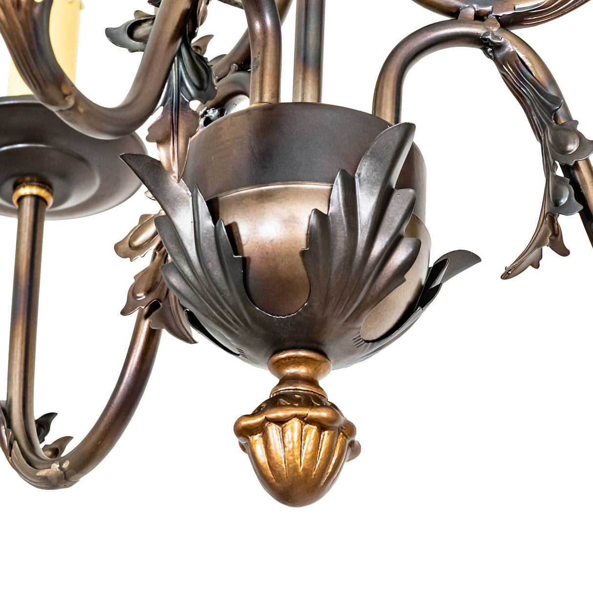 Close-up center detail of French Elegance chandelier showing sculpted ornament base.