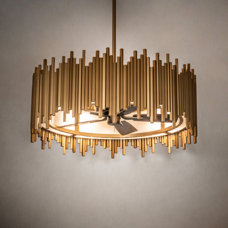 Illuminated Frequency chandelier fan casting warm light through Statuario Idalight lens.
