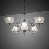 Gas and electric 6 light chandelier illuminated in an ambient interior setting.