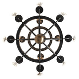 Bottom view of chandelier highlighting circular frame and gold finial.