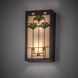 Ginkgo wall sconce mounted on a wall, glowing warm light.