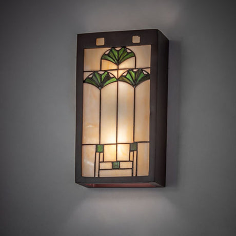 Ginkgo wall sconce mounted on a wall, glowing warm light.