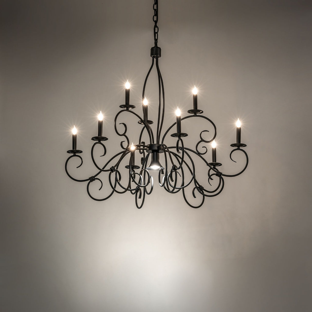 Satin black Grace chandelier installed in dark room setting.