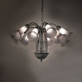 Gray pond lily chandelier glowing in ambient room setting.