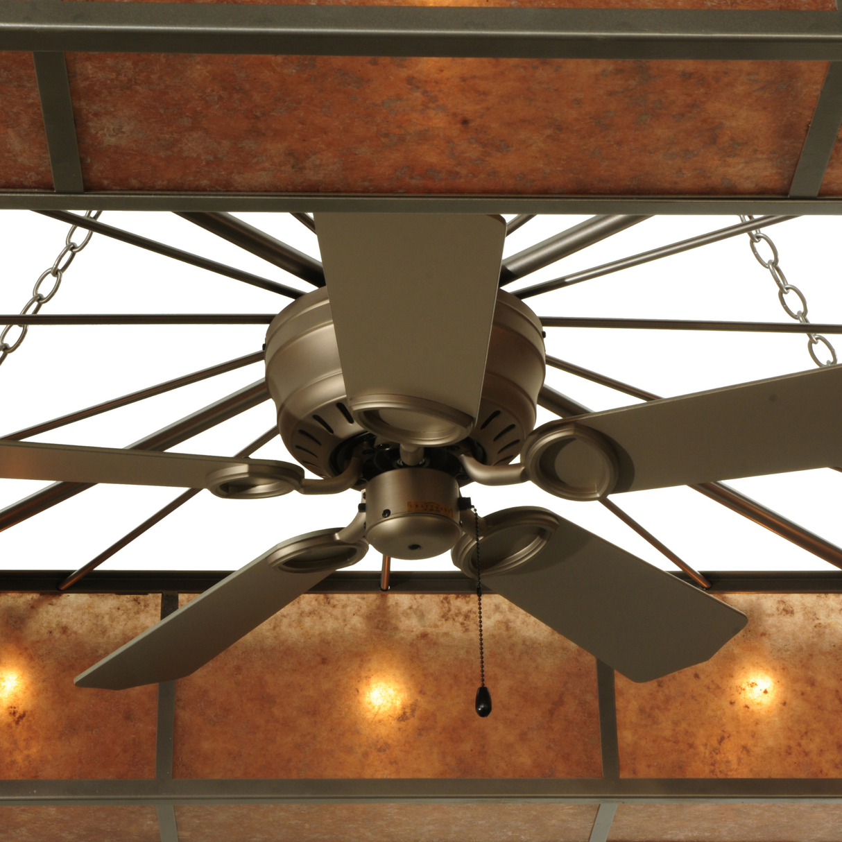Close-up of brushed nickel fan blades framed by glowing mica panels.