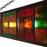 Close-up of vibrant stained glass textures with red and green hues.