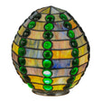 Lit view of the jeweled beehive shade with vibrant emerald and earthy tones glowing warmly.