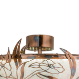 Close-up of ceiling canopy and leaf design with burnished brass finish.