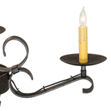 Detailed view of Laramie chandelier arm and faux candlelight.