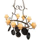 Angled view of Laramie pot rack chandelier glowing with warm light.
