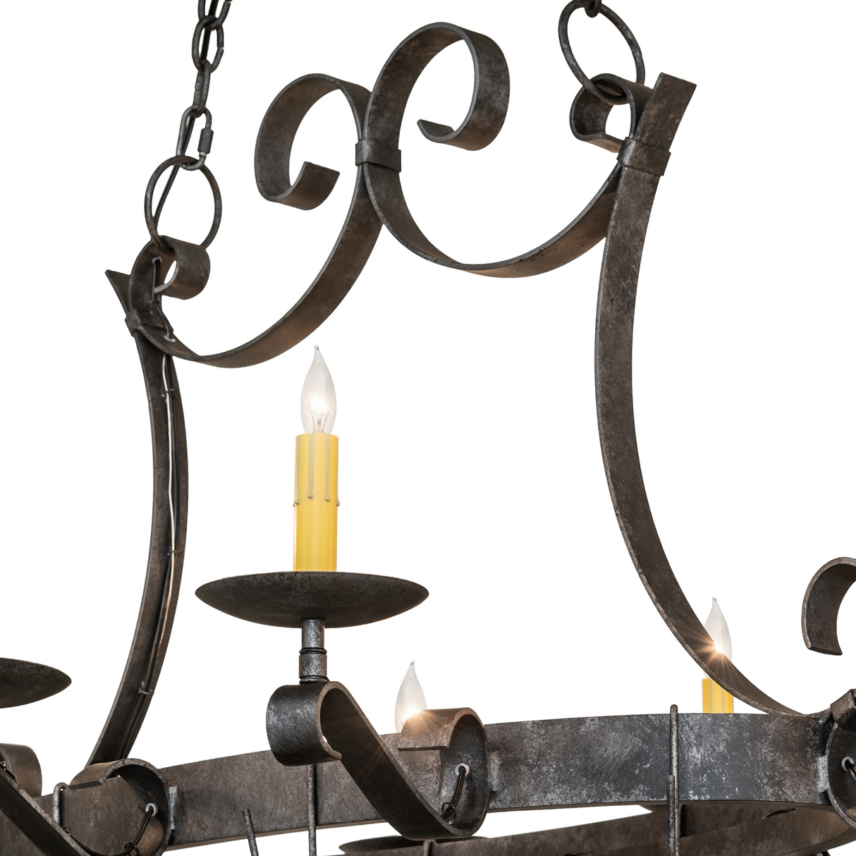 Close-up of Laramie pot rack chandelier scrollwork and candlelight.
