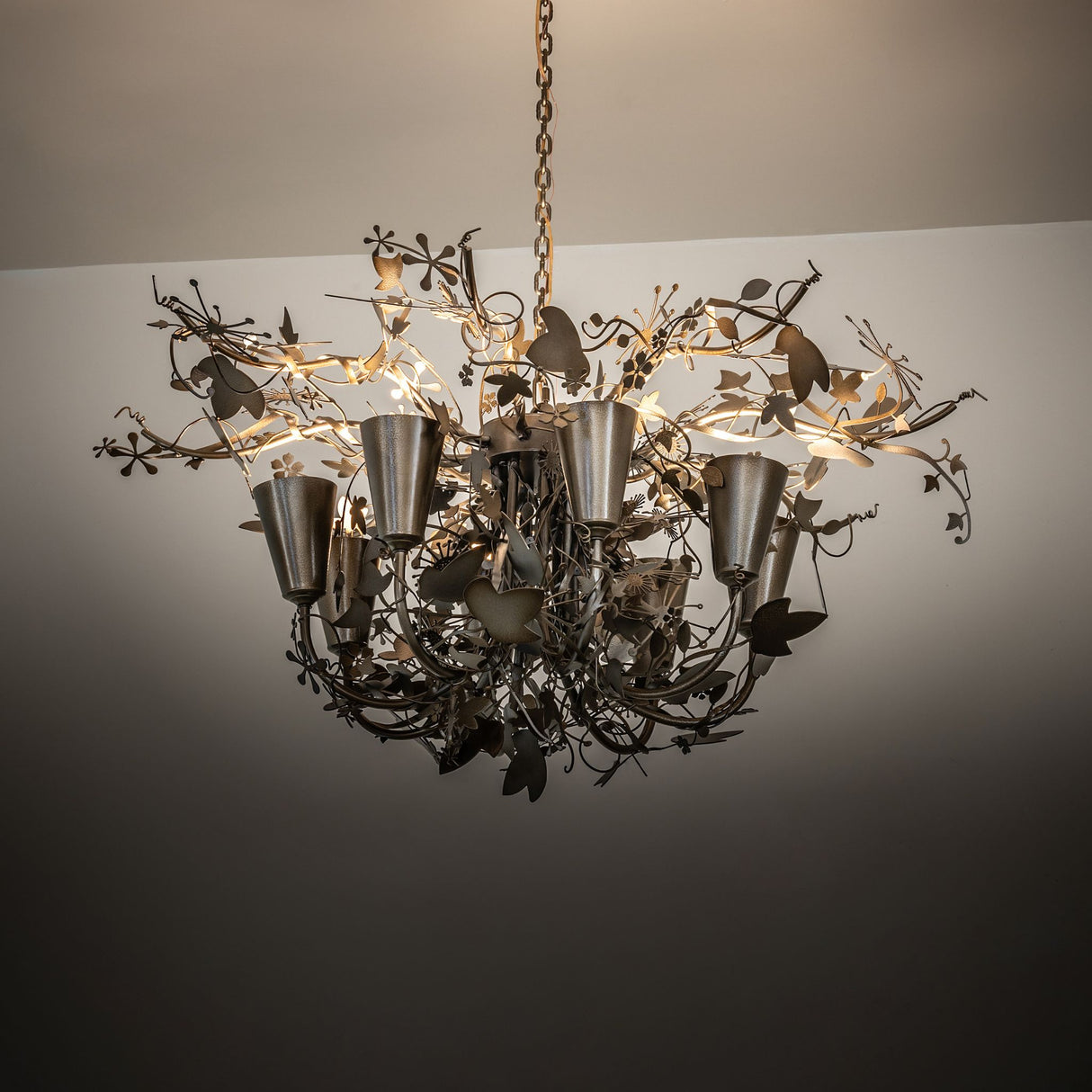Lau Lau 8 light chandelier ambient view in interior setting.