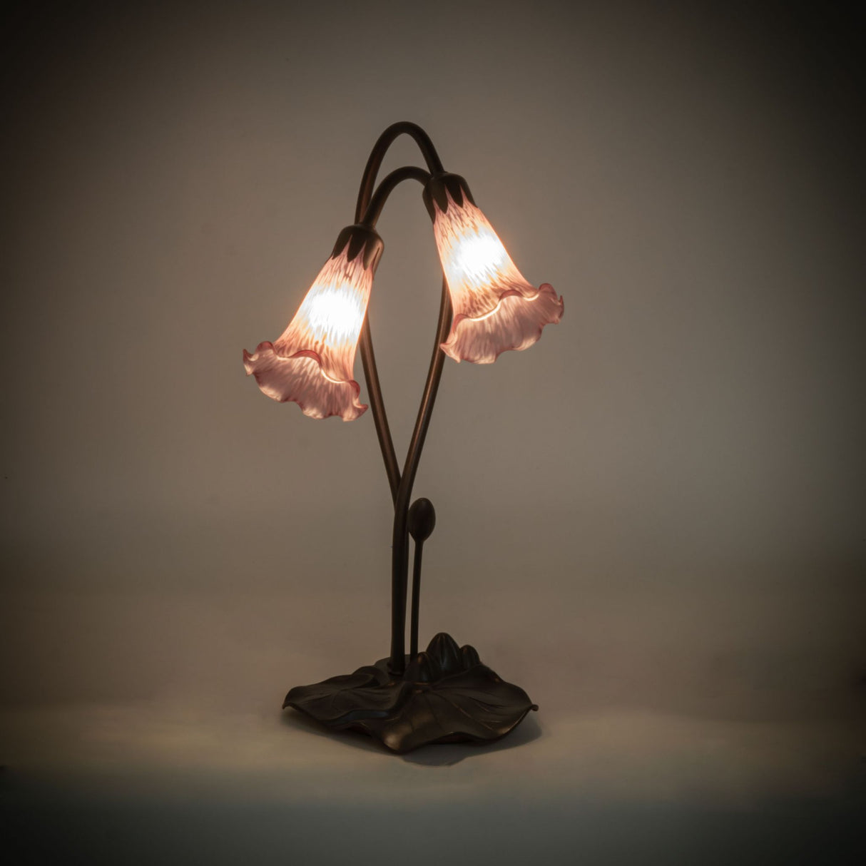 Illuminated view of the Lavender Pond Lily accent lamp glowing with soft lavender hues.