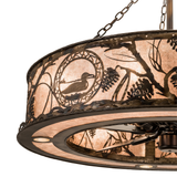 Close-up of loon silhouette and pinecone design on illuminated mica diffuser.