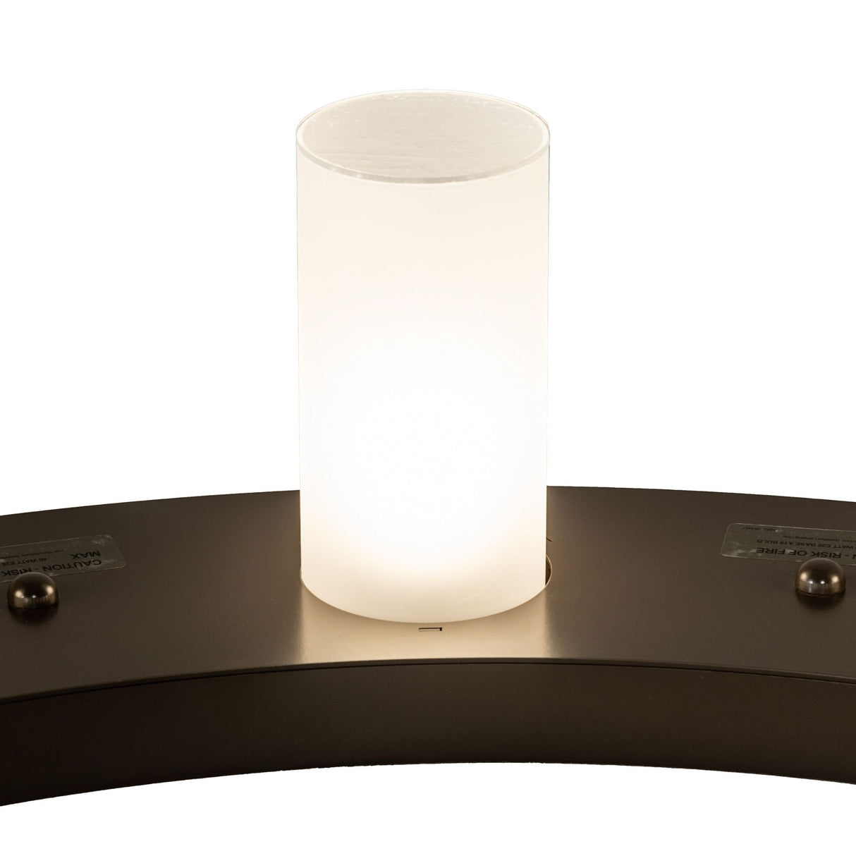 Close-up of frosted glass cylinder shade on chandelier.
