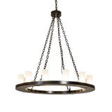 Lit view of 12 light chandelier illuminated with frosted glass cylinder shades.