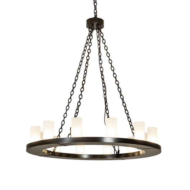 Lit view of 12 light chandelier illuminated with frosted glass cylinder shades.