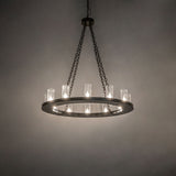 Loxley 12-light bronze chandelier glowing in inside room setting.