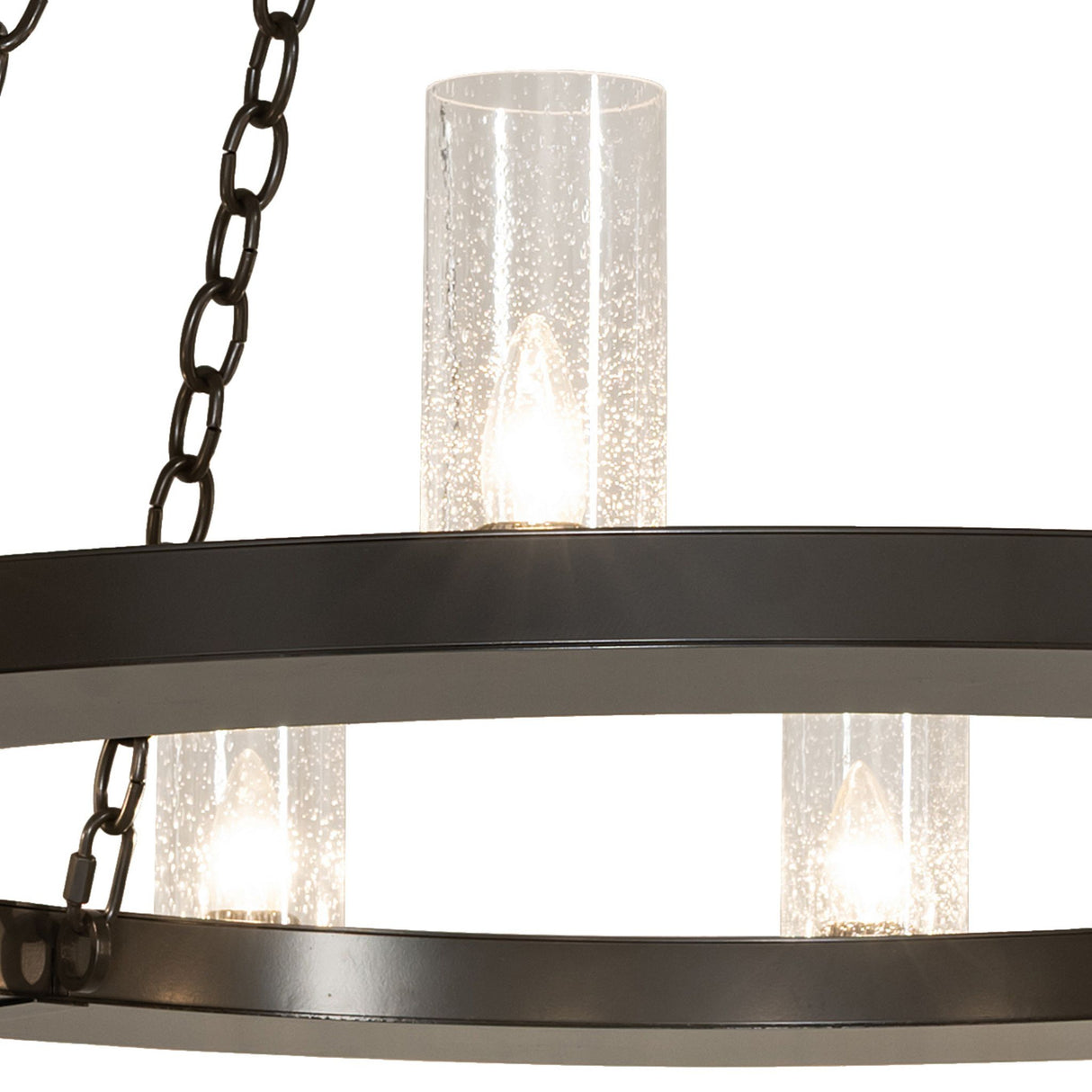 Lit seeded glass cylinder detail on Loxley chandelier.