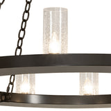 Lit seeded glass cylinder detail on Loxley chandelier.