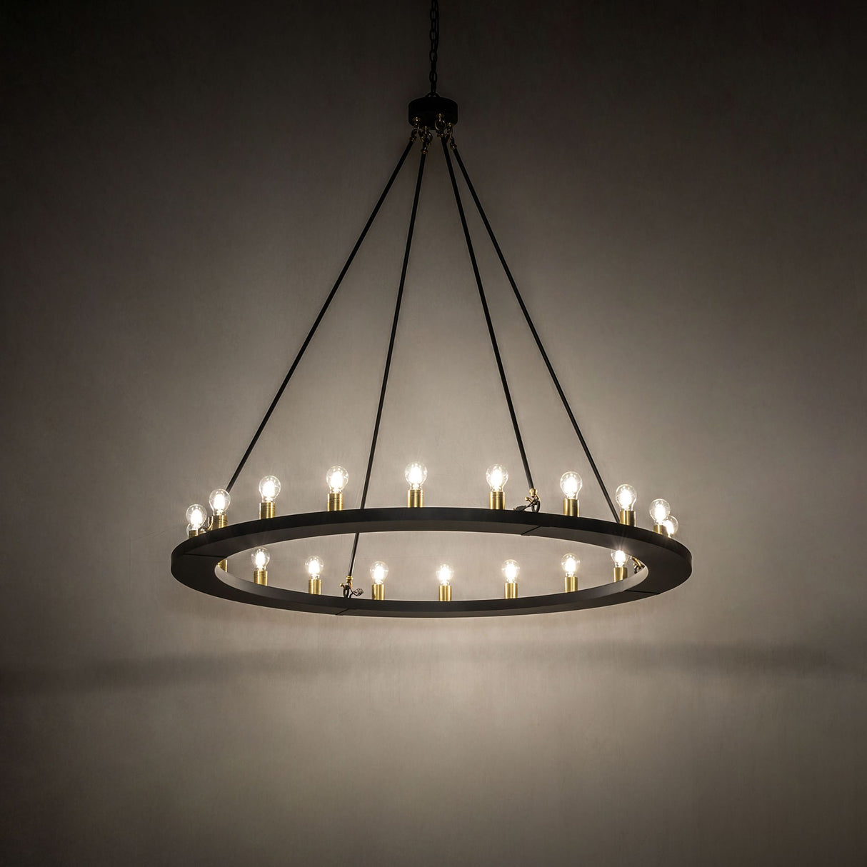 Loxley 20 light chandelier glowing in ambient setting with warm light distribution.
