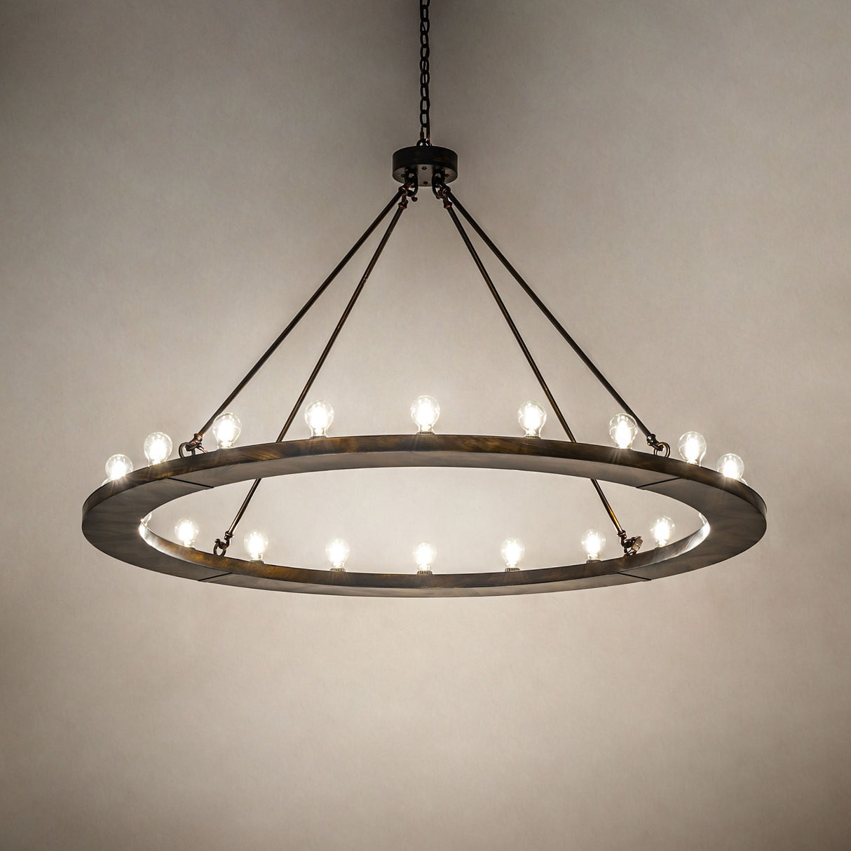 Loxley 20 light chandelier creating soft ambient illumination in a dark room setting.