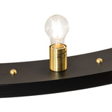 Close-up of Edison-style bulb mounted in brass socket on chandelier.