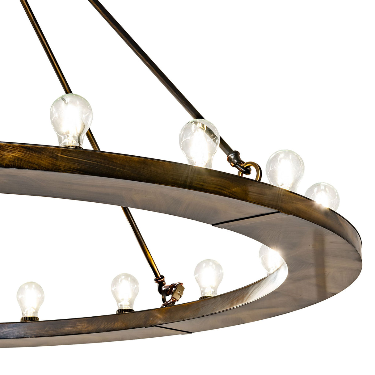 Close-up showing illuminated bulbs mounted on the circular metal ring with suspension rods.