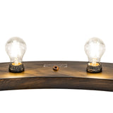Detailed view of the glowing Edison bulbs secured to the antique black finished metal ring.
