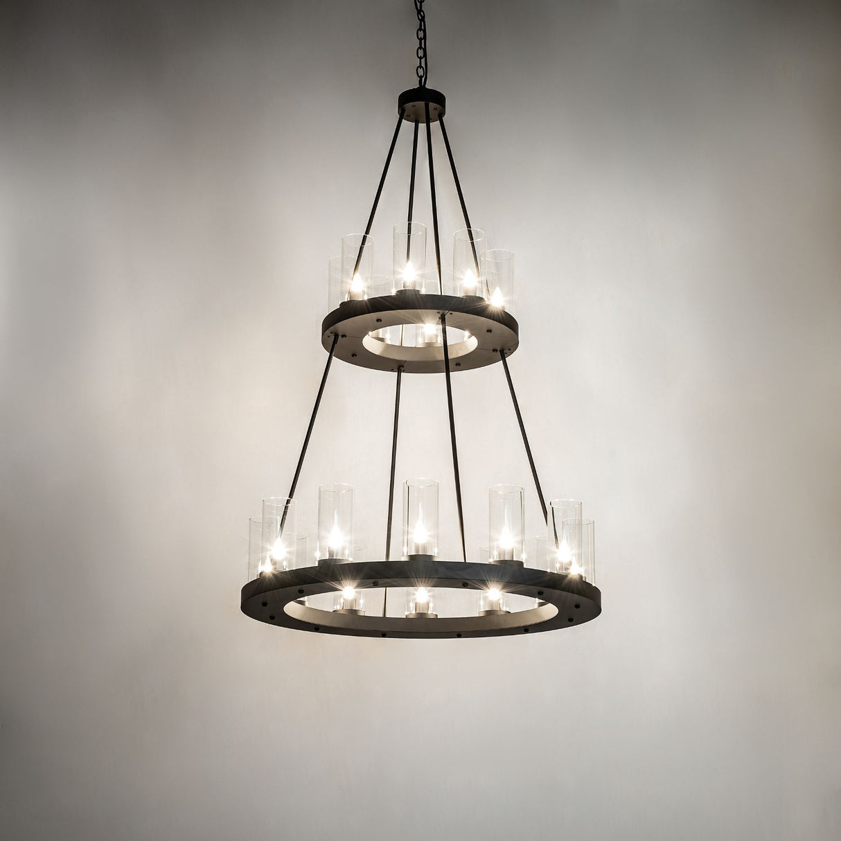Loxley two-tier chandelier illuminated in interior space with warm ambient lighting.