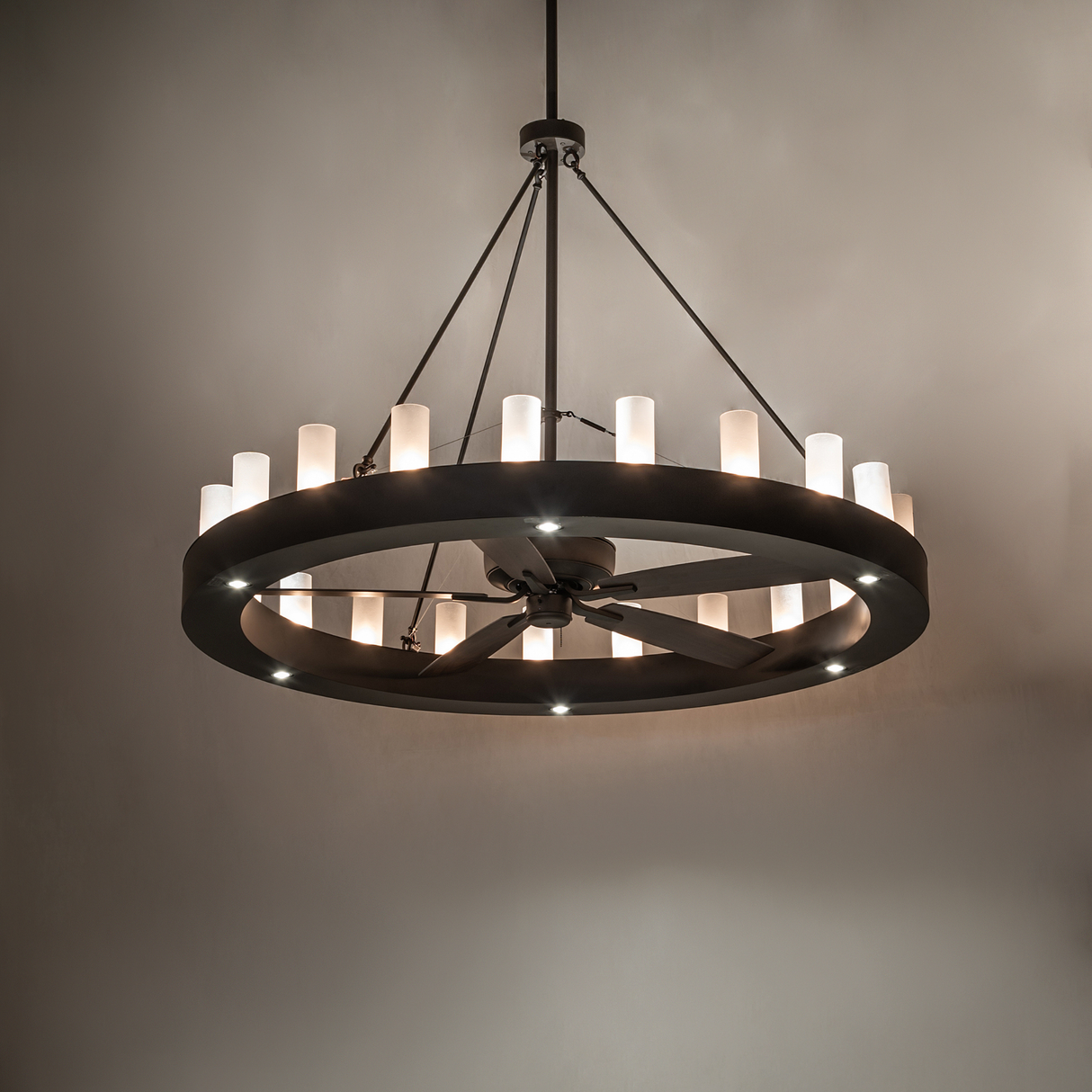 Loxley 21 Light Chandel-Air chandelier fan glowing warmly in ambient room lighting.