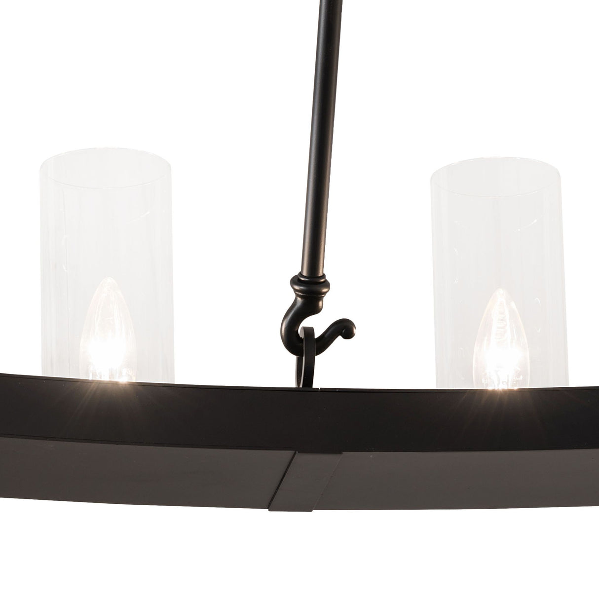 Closeup view of chandelier showing clear glass cylinder shades and solar black metal ring.
