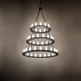 Ambient view of chandelier showing warm glow in a dim interior setting.