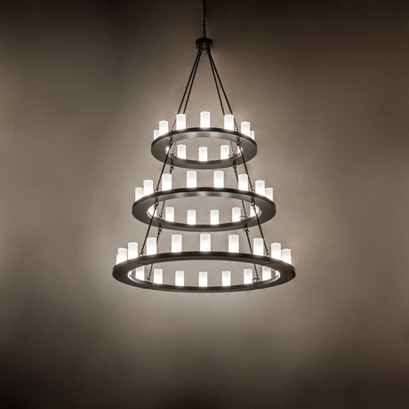 Ambient view of chandelier showing warm glow in a dim interior setting.