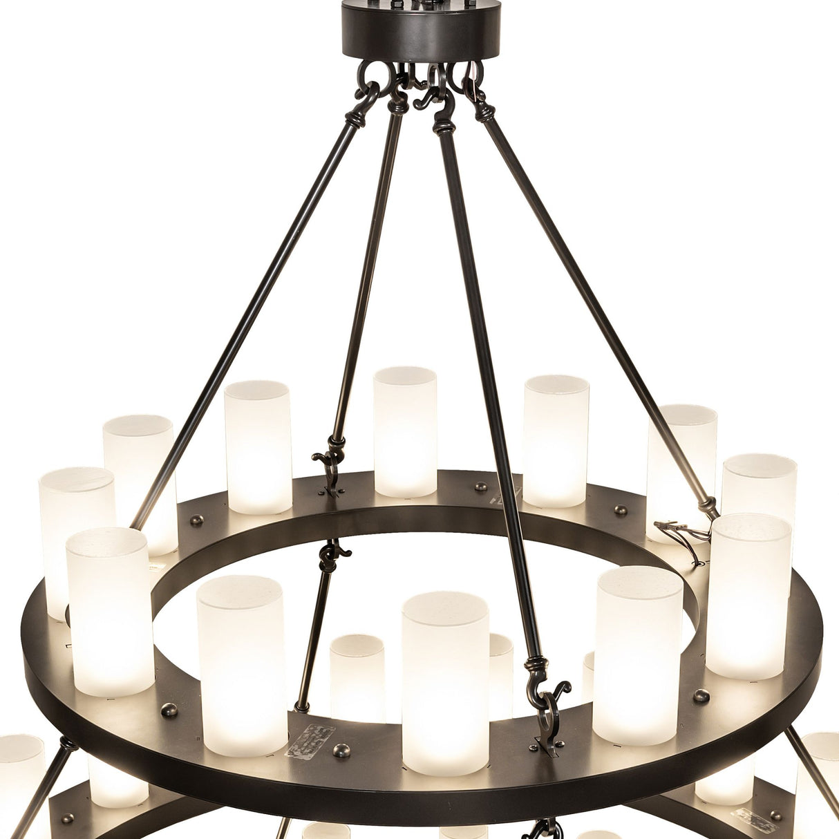 Close-up of the three-tier chandelier showing cylindrical glass lights mounted on circular ring.