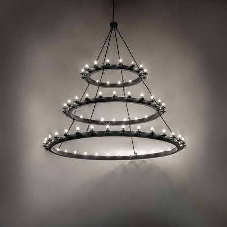 Dark room-lit view of the Loxley three-tier chandelier illuminating the surrounding space.