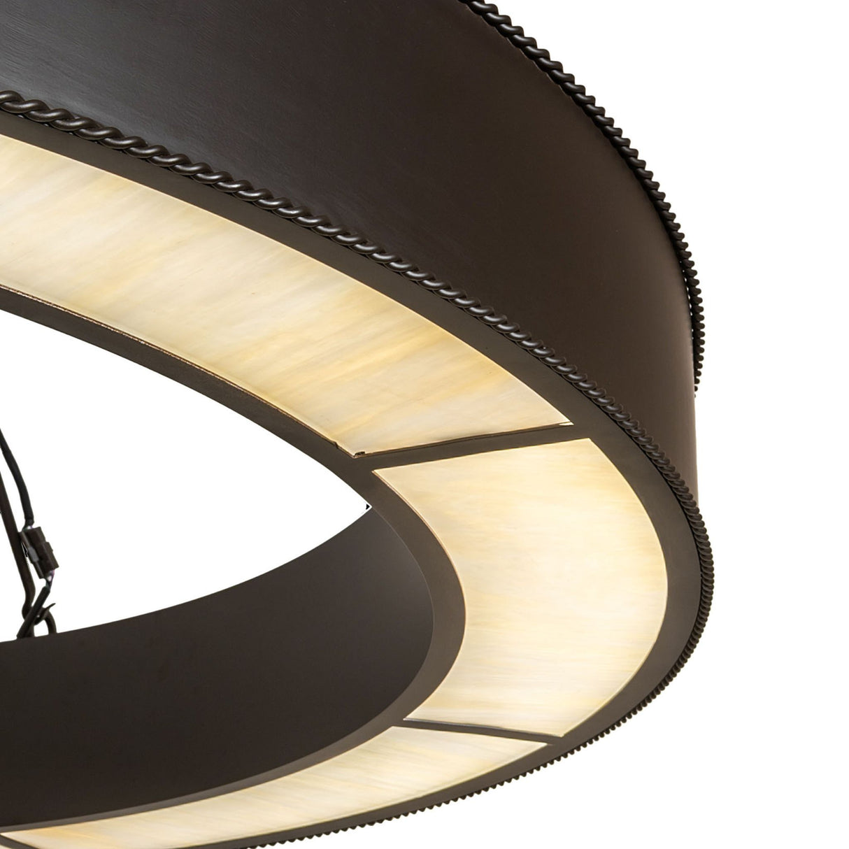 Close-up of beige art glass diffuser with rope edge trim.