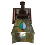 Close-up showing the lit stained glass of the wall sconce.