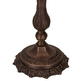Close-up of bronze lamp base with intricate leaf detailing and scalloped edges.