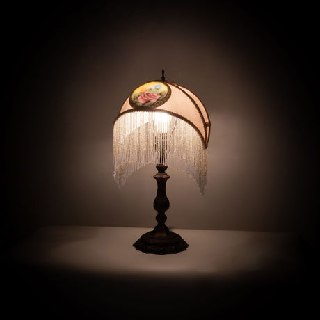 Accent lamp illuminated with ivory shade and reverse-painted rose medallion design.