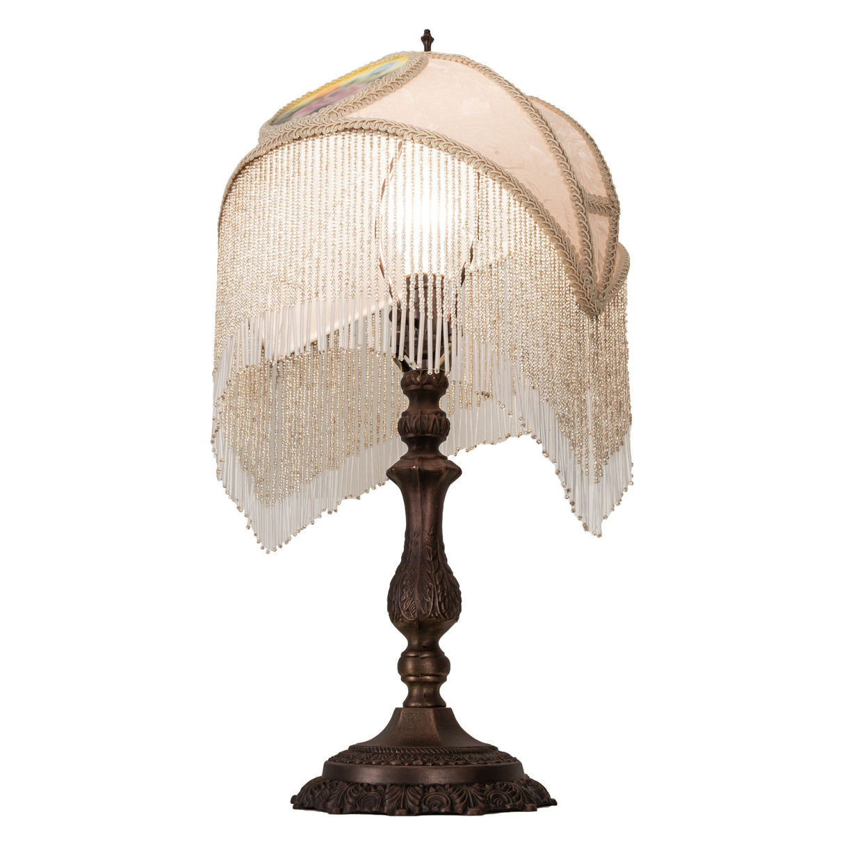 Side view of ivory damask shade lamp with bronze base and fringe detail.