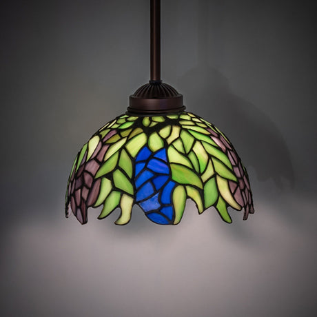 Illuminated view of the Tiffany Honey Locust Pendant with Mahogany Bronze finish.
