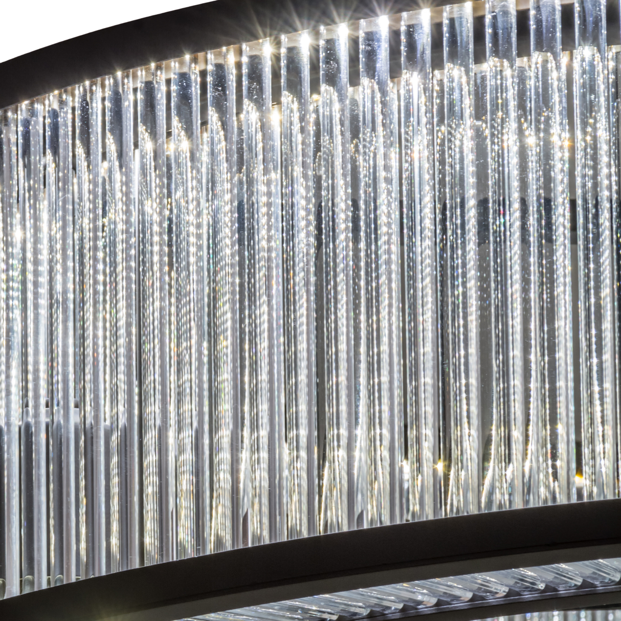 Close-up lit view highlighting shimmering prismatic glass rods and modern detailing.