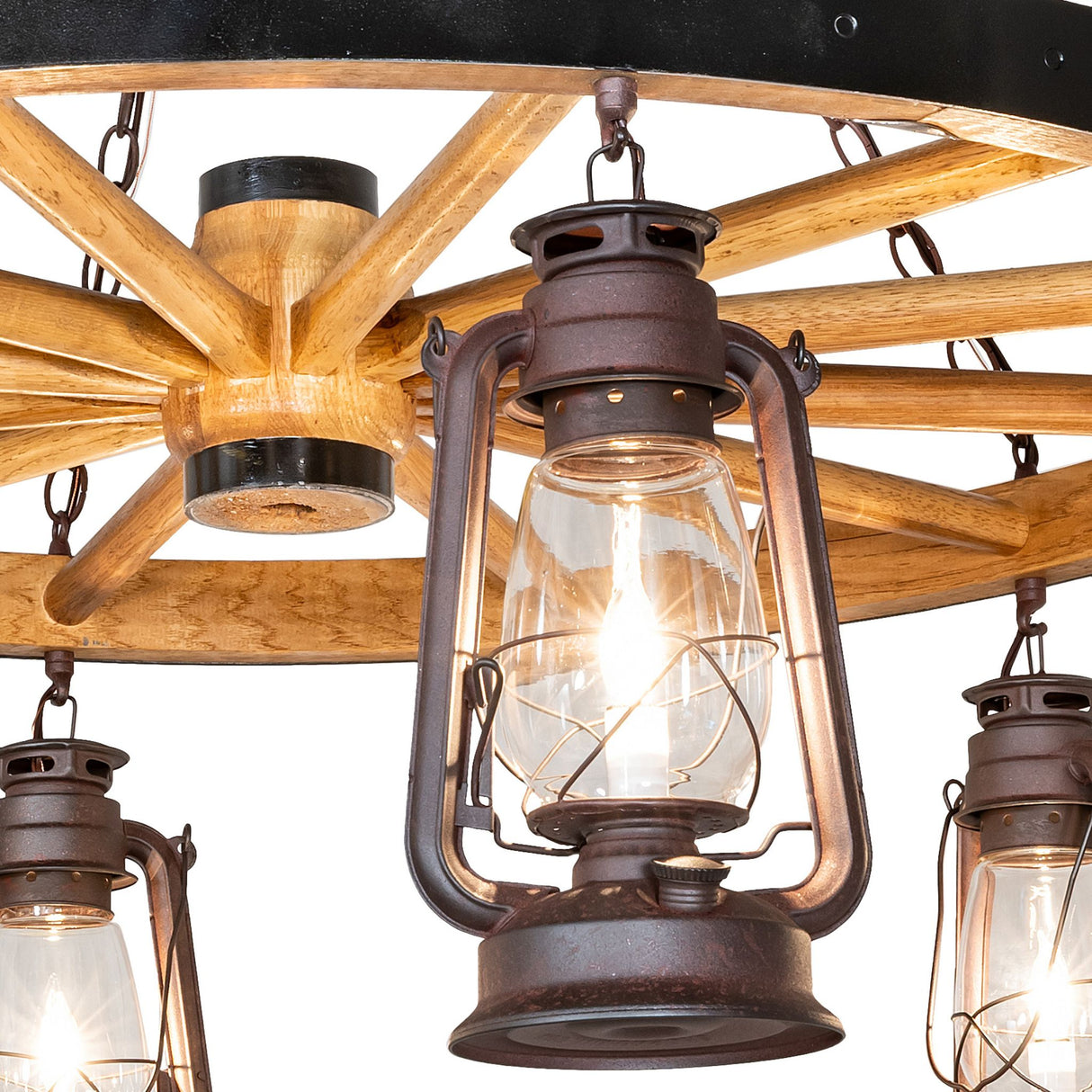 Close-up of rustic lantern light on wagon wheel chandelier.