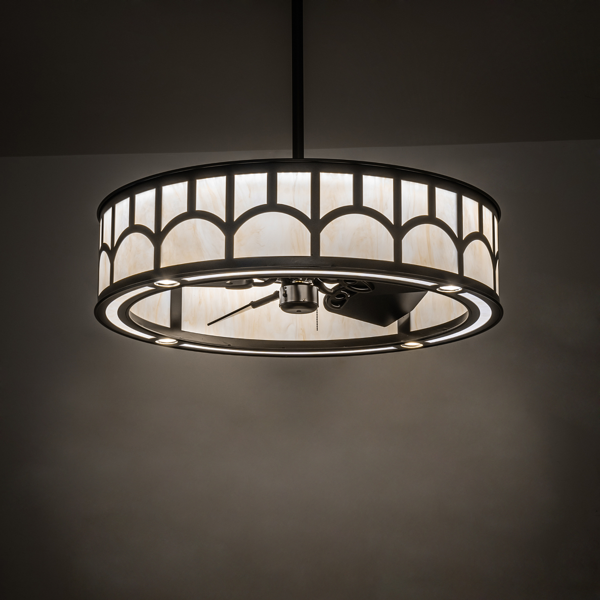 Room-lit view showing glowing diffuser and integrated ceiling fan.