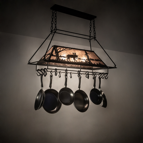 Moose at Lake 3-light pot rack glowing warmly in rustic kitchen setting.